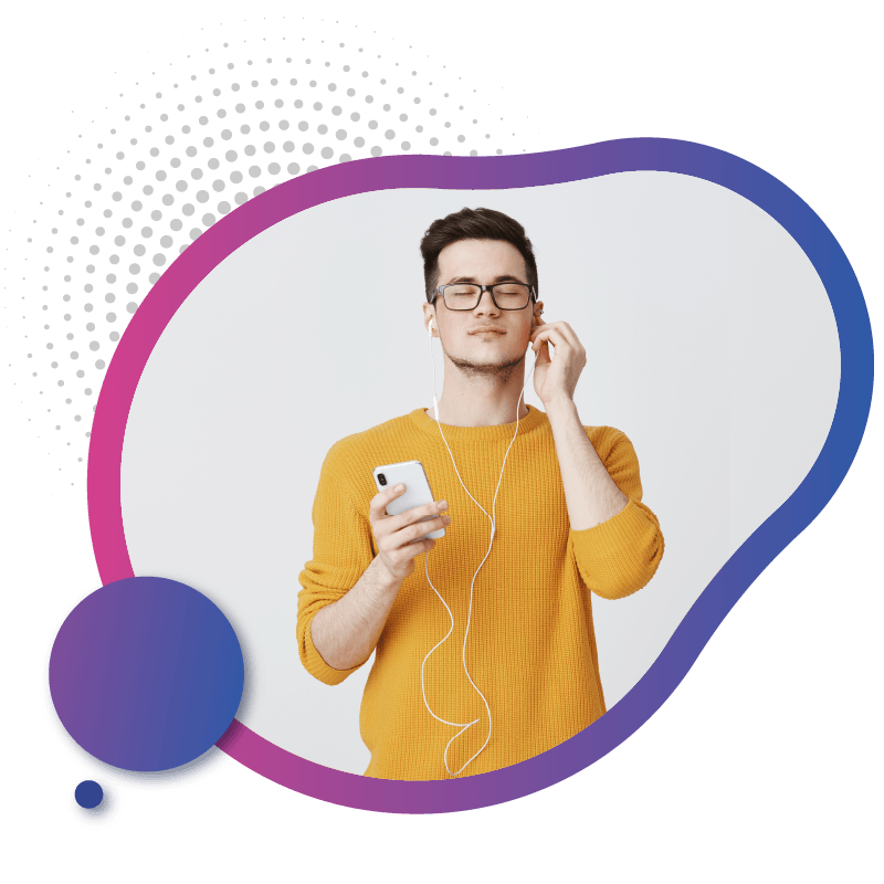 A person in a bright yellow sweater holds a smartphone and listens to music with earbuds, representing the best digital SIM technology in Australia for effortless connectivity.